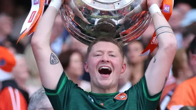 Armagh's Blaine Hughes lifts the Sam Maguire trophy