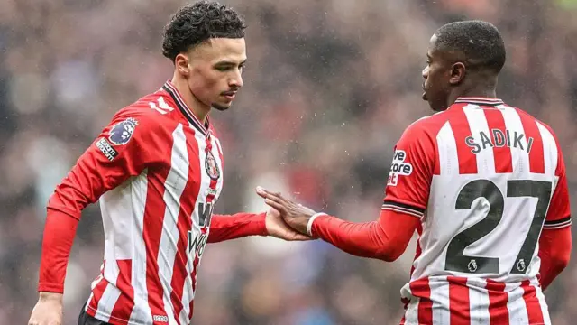 Chemsdine Talbi of Sunderland touches hands with Noah Sadiki of Sunderland during the Premier League match between Sunderland and Manchester United at Stadium Of Light