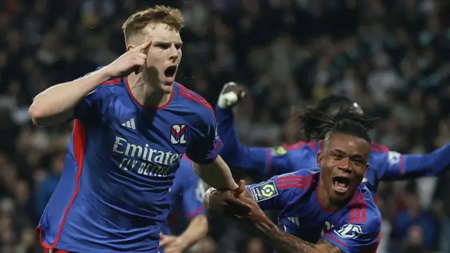 Jake O'Brien (L) celebrates after scoring for Lyon