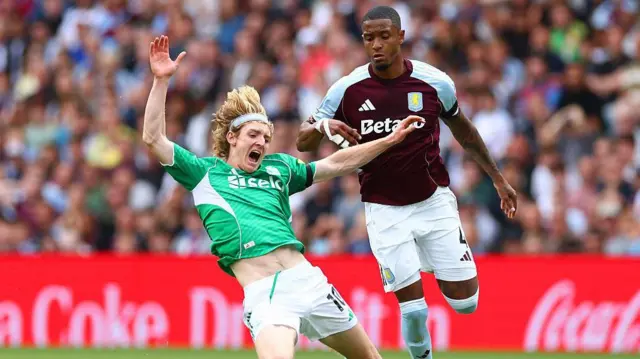 Ezri Konsa of Aston Villa fouls Anthony Gordon of Newcastle United and is subsequently shown the red card during the Premier League match between Aston Villa and Newcastle United at Villa Park 