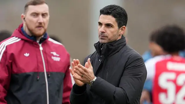 Mikel Arteta applauds fans on the pitch