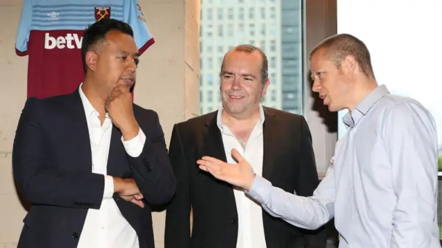 Karim Virani (l) speaks at a partner meeting during his first stint at the club