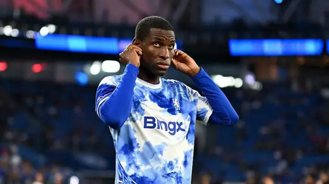 Nicolas Jackson holding both ears while in an open training session at Chelsea