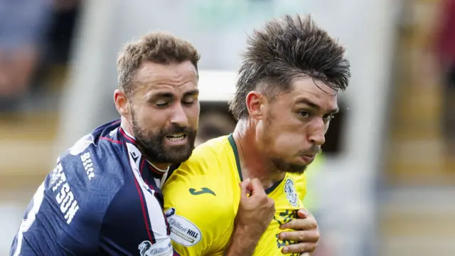 Dundee's Clark Robertson and Hibernian's Kieron Bowie