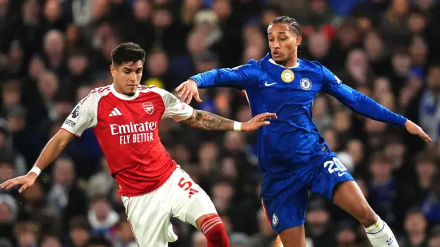 Chelsea and Arsenal players challenge for the ball