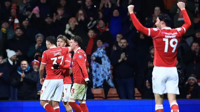 Wrexham players celebrate after Josh Windass' penalty against Sheffield United