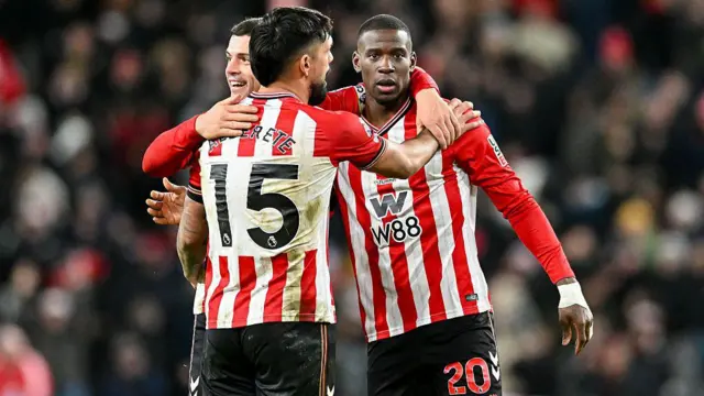 Nordi Mukiele, Granit Xhaka, and Omar Alderete embrace after full-time