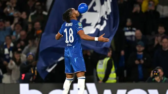 Christopher Nkunku celebrates by blowing up a balloon