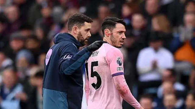 Adam Smith leaving the pitch against Aston Villa with a head injury.
