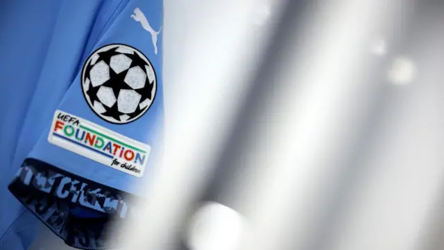 A general view of Champions League/Uefa branding on the sleeve of a Manchester City shirt