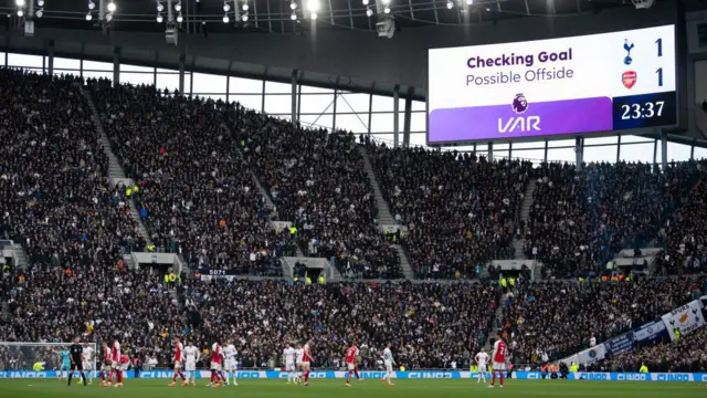 Arsenal and Tottenham players waiting for the VAR decision that ultimately denied Micky van de Ven a goal during their Premier League meeting in April