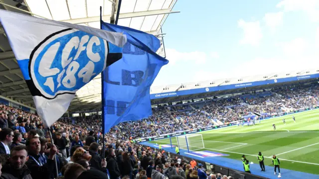 Leicester City fans wage a huge flag at the King Power Stadium