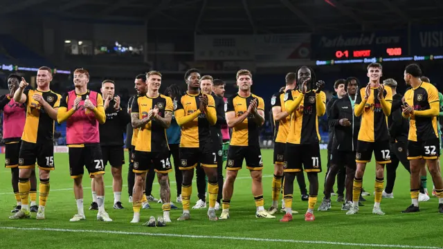 Newport players celebrate their win at Cardiff