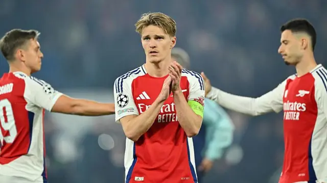 Martin Odegaard applauds fan