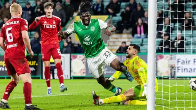 Hibs' Rocky Bushiri (second right) scores against Aberdeen