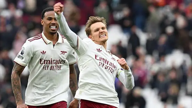 Arsenal's Gabriel Magalhaes and Martin Odegaard celebrate after the Premier League match between West Ham United and Arsenal at London Stadium