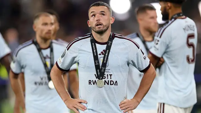 John McGinn of Aston Villa looks dejected after the team's defeat in the UEFA Super Cup