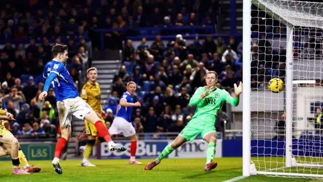 Portsmouth forward Callum Lang scores against Blackburn