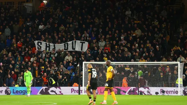Banner in the stadium saying Shi out 
