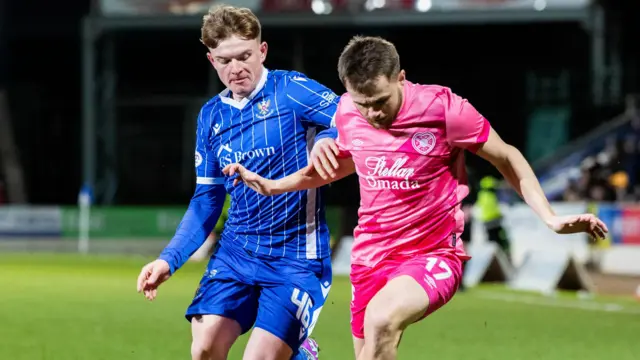 Alan Forrest and Fran Franczak tussle for the ball