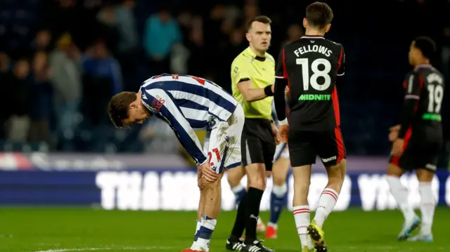 A West Brom player looks dejected