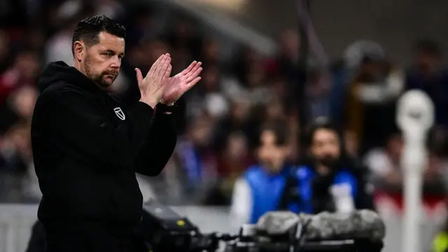 Pierre Sage clapping on the touchline