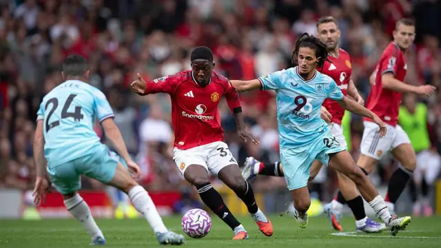 Kobbie Mainoo of Manchester United and Hannibal Mejbri of Burnley battle for possession