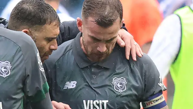 Omer Riza and Joe Ralls coming off the pitch after losing to Portsmouth, Riza has an arm around the shoulders of Ralls.