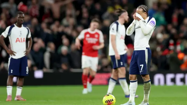 Xavi Simmons and other Tottenham players look dejected on pitch against Arsenal