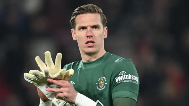 Luton Town goalkeeper Thomas Kaminski clapping the fans with his gloves