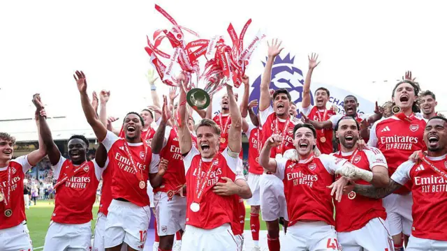 Martin Odegaard of Arsenal lifts the Premier League trophy