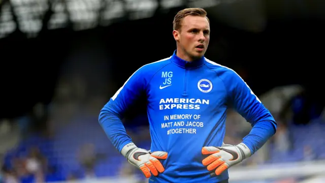 Goalkeeper David Stockdale warms up in Brighton training gear wearing personalised gloves and shirt to honour two of the victims of the Shoreham air crash Matt and Jacob in 2015