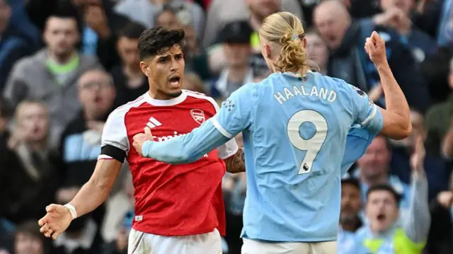 Piero Hincapie of Arsenal clashes with Erling Haaland of Manchester City