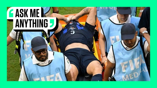 Manuel Ugarte being carried off on a stretcher during Uruguay's World Cup defeat by Spain. The image is surrounded by a green border with 'Ask Me Anything' in the top corner.