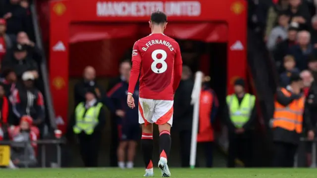 Bruno Fernandes of Manchester United leaves the pitch after being shown a red card during the Premier League match between Manchester United FC and Tottenham Hotspur FC at Old Trafford