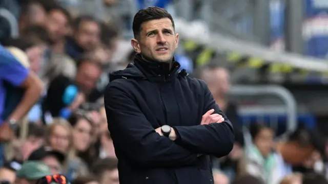 Portsmouth boss John Mousinho looks on from the sidelines