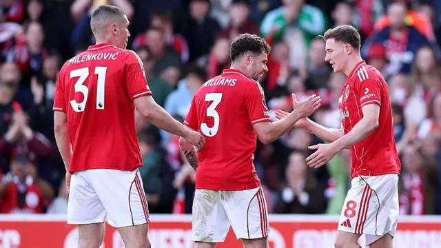 Elliot Anderson of Nottingham Forest celebrates scoring his team's first goal with teammates Neco Williams and Nikola Milenkovic
