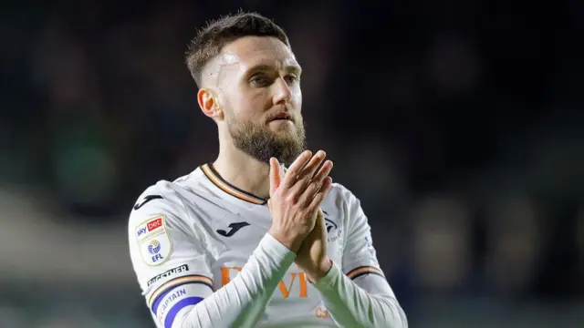 Matt Grimes claps Swansea's fans after their win at Plymouth