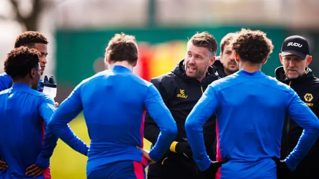 Rob Edwards instructs players during training