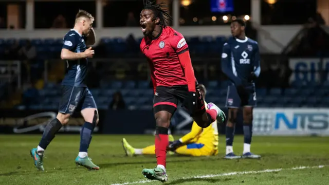 Toyosi Olusanya celebrates his equaliser against Ross County