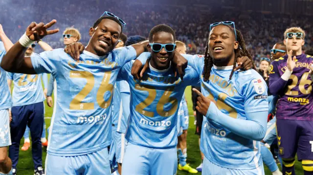 Ephron Mason-Clark, Romain Esse of Coventry City and Brandon Thomas-Asante celebrate Coventry City's title-winning victory over Portsmouth 