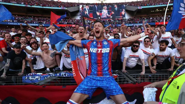 Joel Ward of Crystal Palace celebrates with the Holmesdale Ultras