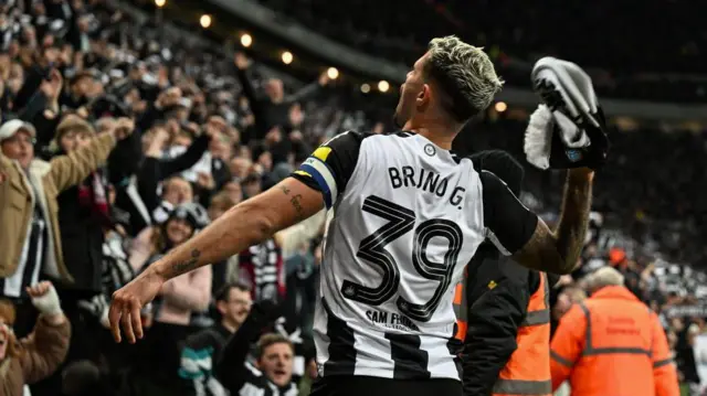 Bruno Guimaraes celebrates in front of Newcastle fans