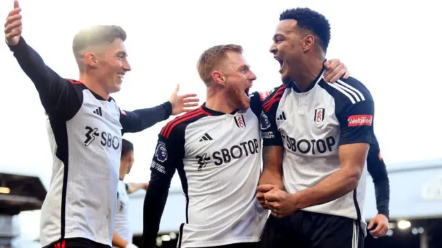 Harry Wilson (left), Harrison Reed (centre) and Rodrigo Muniz (right) celebrate scoring a goal against Brighton