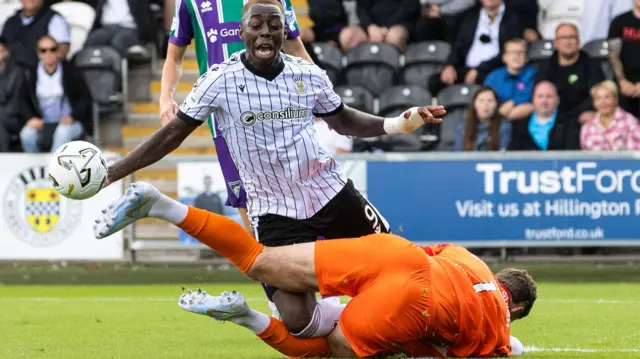 St Mirren's Eseosa Sule collides with Dunfermline Athletic goalkeeper Aston Oxborough