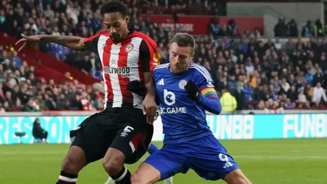 Brentford's Ethan Pinnock and Leicester's Jamie Vardy challenge for the ball