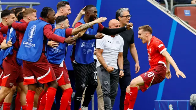 Switzerland's Michel Aebischer celebrates with teammates during their win over Hungary