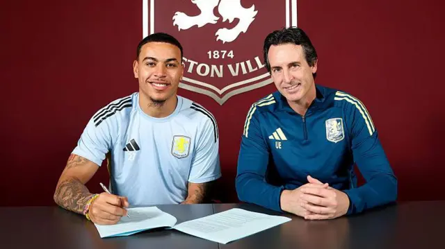 Morgan Rogers signing a contract alongside Unai Emery at training ground