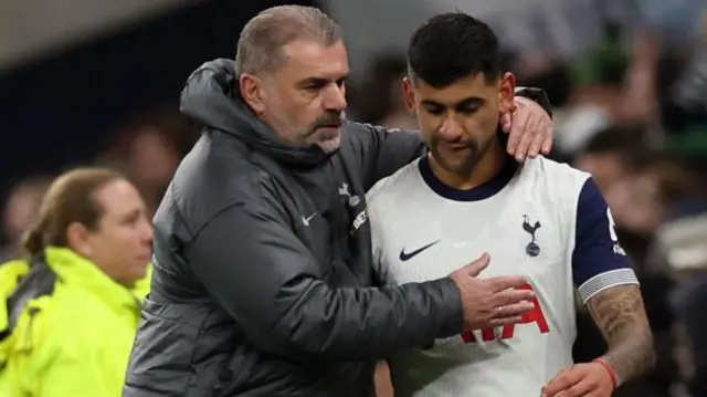 Romero is consoled by Postecoglou after being forced off with an injury