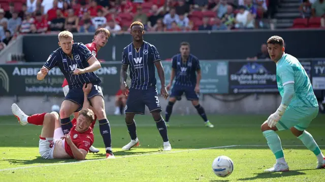 Josh Coburn scores Millwall's second goal at Bristol City on the opening weekend of the Championship season, sliding the ball past City keeper Sam Tickle